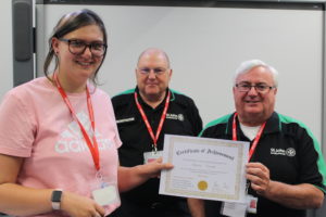 Staff receiving certificate from St Johns' Ambulance