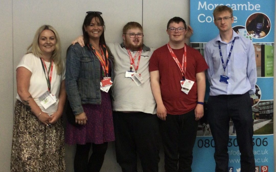 A photograph of Jared and Sean meeting staff from Lancaster and Morecambe College