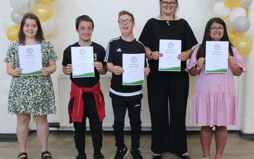 Graduates at our Barrow Campus holding up their graduation certificates